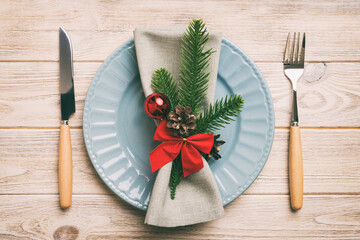 Sticker - Christmas table place setting with christmas decor and plates, kine, fork and spoon. Christmas holiday background. Top view