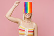 © ViDi Studio - Young happy blond lesbian woman 20s she wear colorful knitted top yellow hat hold cover eyes with striped flag isolated on plain pastel light pink background. People lgbtq lifestyle fashion concept.