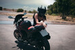 slim sexy girl posing by motorcycle