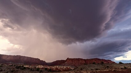 Wall Mural - Monsoon storm moving through the Utah desert in timelapse over the cliffs at Capitol Reef.