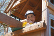 © Evgeniy Trofimenko - The boy looks out of the playhouse. Thoughtful look. Age approximately 6 years old. Playground. Wooden building. Childhood. City Park. Countryside.