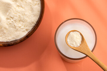 Glass of fresh liquid and powdered milk