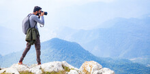 photographer holding the camera in mountains