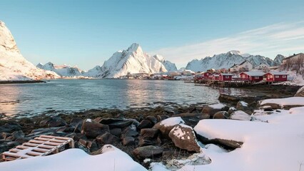 Wall Mural - Scandinavian fishing village and snow mountain range on coastline in Reine town at Lofoten Islands, Norway