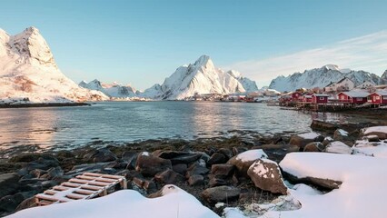 Wall Mural - Scandinavian fishing village and snow mountain range on coastline in Reine town at Lofoten Islands, Norway