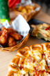 barbecue spicy chicken wings and Tasty, flavorful pizza with Mozzarella cheese, sausage, tomato sauce, Margherita, mushroom on wooden background