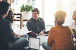 © Camerene Pendl/peopleimages.com - Creative business team in a meeting planning and brainstorming together while sitting on the floor. A group of colleagues or coworkers talking and discussing company ideas in a modern office