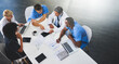 © Delmaine Donson/peopleimages.com - Team of medical workers sitting and meeting with laptops around table. Doctors and staff discussing papers and test results. Healthcare experts handling daily tasks and duties