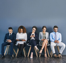 Poster - Group of business people at a job interview at a small startup company with copy space. Businesspeople sitting and waiting in line for a meeting with human resources and applying for work