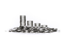 Stack Of Silver Coins On White Background. Economic Recession And Declining Income. Investment And Financial Business.
