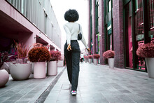 Back View Of African Woman Walking In City