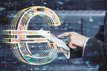 Poster - Close up of businessman hands using smartphone with creative glowing golden tech euro icon hologram on blurry office interior background. Crypto currency and technology concept. Double exposure.