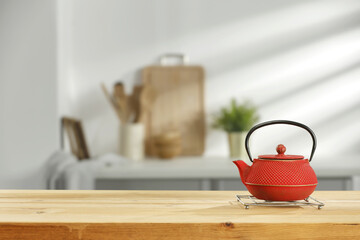 Wall Mural - Wooden desk and red kettle on top 