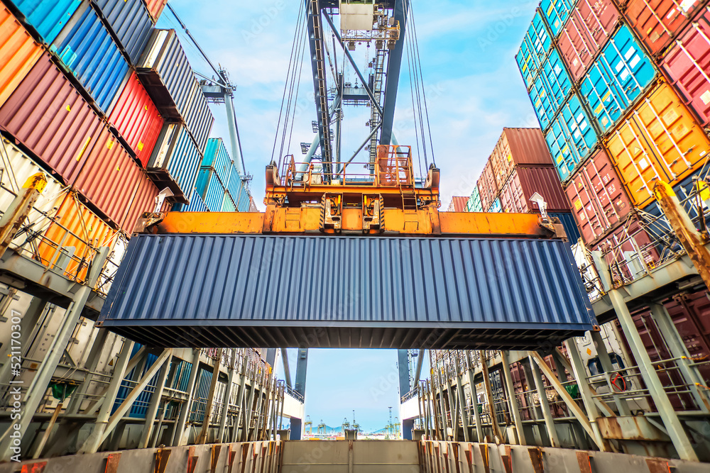 Industrial crane loading Containers in a Cargo freight ship. Container ...