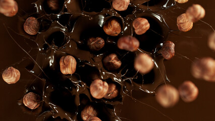 Canvas Print - Freeze motion of falling hazelnuts into melted chocolate.