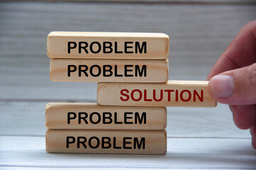 Problem and solution text on wooden blocks.