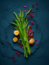 Aspargus And Quail Egg With Blossoms On Blue Powder