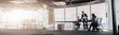 © Yaroslav Astakhov - Team of businessmen communicating together in office with panoramic windows. Blurred background