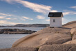 Old lighthouse on red granite in Lysekil on the Swedish west coast