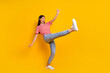 Leinwandbild Motiv Full size portrait of ecstatic glad girl raise leg have good mood dancing isolated on yellow color background