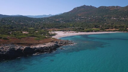 Wall Mural - Aerial view of the translucent water of the Mediterranean sea and the sandy beach of Bodri in the Balagne region of Corsica