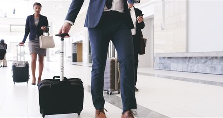 Poster - A confident and professional business man walking with a suitcase while on his trip arriving at a convention centre. A group of traveling corporate executives in suits strolling in a modern building.