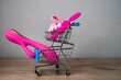 © Anna Ivanovska - supermarket trolley filled with sex toys vibrator and anal butt plugs. Concept of buying adult toys, e shopping
