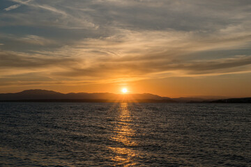  Calm sunset over a coastal mountain range..
