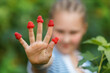 © Татьяна Яблокова - Girl with rasperries on the fingers, peeking through fingers. Kid is showing palm with fresh raspberries from her hand.