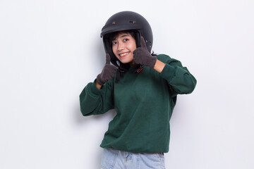 beautiful asian woman with a motorcycle helmet showing a thumbs up ok gesture on white background
