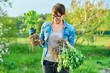 © Valerii Honcharuk - Woman in gardening gloves with shovel holding sedum plant with roots