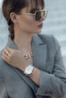 Beautiful stylish white watch on woman hand. Portrait of beautiful woman with stylish silver watch on woman hand.