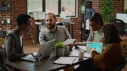 Poster - Diverse team of coworkers analyzing business charts on documents, working on presentation report in boardroom. Using data on documents to plan research in corporate management meeting.