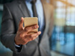 © Koegelenberg/peopleimages.com - Business, phone and hand of a professional man typing a message, browsing online and using a mobile app to communicate. Closeup of male entrepreneur using internet and social media for marketing