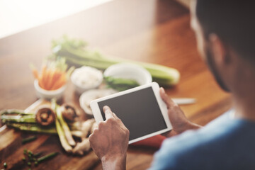 Aufkleber - Closeup of hands of man holding a tablet to search a recipe, do research or look for ingredients while cooking dinner, lunch or breakfast. Scrolling online, browsing app and searching for meal ideas