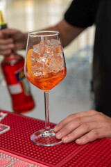 Wall Mural - Spritz Cocktail in glasses with ice and orange slice on light  background.