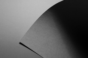 Poster - carbon grey abstract geometric background with triangle corner of textured sheet with shadow as mono