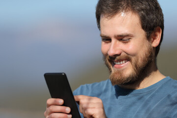 Poster - Happy man using mobile phone a sunny day