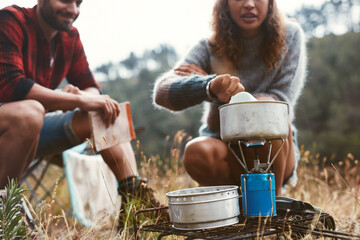 Woman preparing food on a camping stove