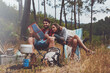 © Jacob Lund - Young couple looking at a travel map while camping