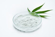 © boommaval - cannabidiol or CBD powder in glasses plate, Petri dish, and cannabis leaves on white background. weed concept