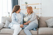 © standret - With flowers in hands. Happy mother's day. Senior woman and daughter is together at home