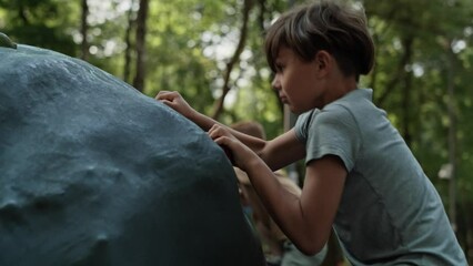 Wall Mural - Two caucasian elementary boys climbing at playground in sunny day. Shot with RED helium camera in 8K. 