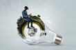 © Sergey Nivens - Man sitting. Concept of renewable energy and circular economy.