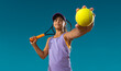 Tennis player. Beautiful girl teenager and athlete with racket in pink sporswear and hat on tennis court. Fashion and sport concept.