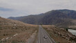 Chuya highway with traffic cars and mountains in valley of Altai
