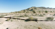 Panning A Rusted Barbed Wire Fence In An Arid Desert - Lancaster, California