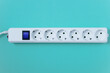 © Iuliia Alekseeva - White electrical surge protector with a six sockets.