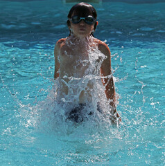 Boy playing in a pool