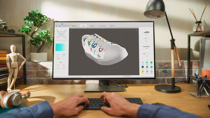 Leinwandbilder - POV First Person View: Young Male Footwear Designer Works on 3d Model of Shoe and Change Colours on It While Working on Desktop Computer in Creative Space. Shoe Production Procedure Concept.